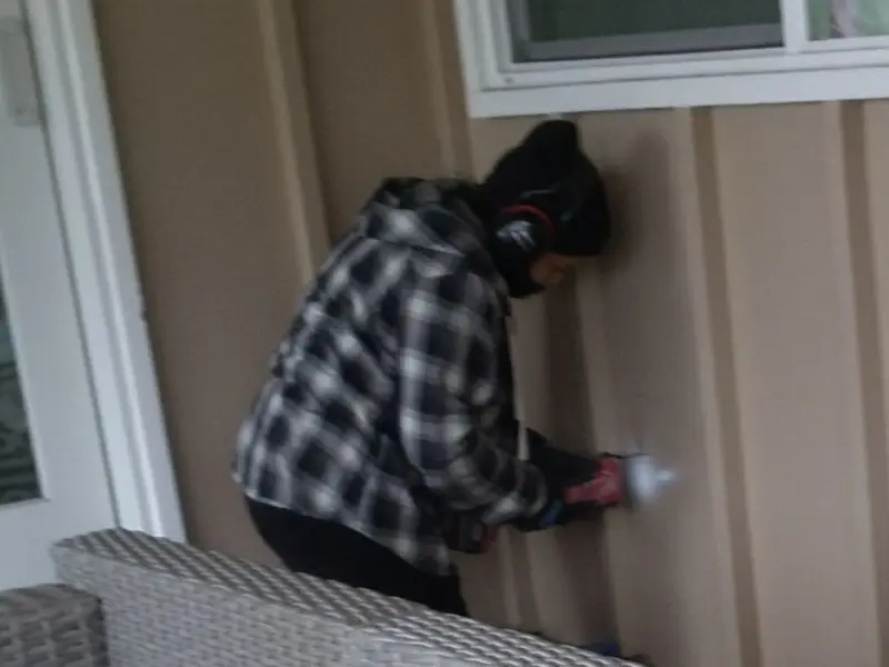 Professional electrician installing an exterior outlet in Loyola